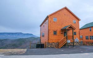 a large wooden cabin in the mountains with a view at A Splash of Heaven in Pigeon Forge