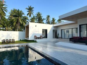 an exterior view of a house with a swimming pool at Pisingha Pool Villa Khanom in Khanom