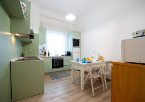 a kitchen with a sink and a table with a tablektop at Frog 30 in Gabicce Mare