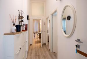 a hallway with a round mirror and a white wall at Frog 30 in Gabicce Mare