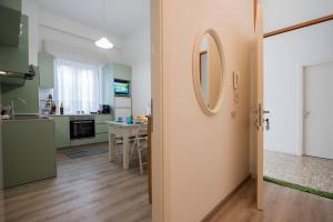 a kitchen and living room with a mirror on the door at Frog 30 in Gabicce Mare