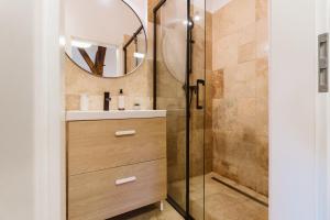 a bathroom with a shower and a sink and a mirror at Townhouse Boutique in Sibiu +46 photos