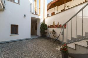 a courtyard of a building with a table and chairs at Townhouse Boutique in Sibiu