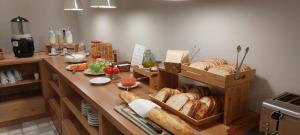 a kitchen with a table filled with lots of bread at Hotel Saurat in Espot