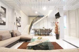 a living room with a couch and a table at Tasqya Costel syariah in Parit