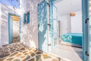 a room with a blue door and a bed at Villa Kalathos Dream Galazio in Kalathos +56 photos