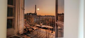 a balcony with a view of the eiffel tower at RIVAS FCA-PARIS TERRAZA apt in Rivas-Vaciamadrid
