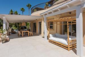 a patio with a swinging bed on a porch at San Roque 5001 Golf&Relax in San Roque