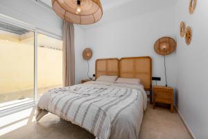 a bedroom with a bed and a large window at San Roque 5001 Golf&Relax in San Roque +36 photos