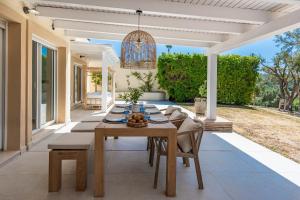 a dining room with a table and chairs on a patio at San Roque 5001 Golf&Relax in San Roque
