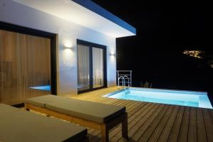 a swimming pool on the roof of a building at night at Villa Gianna Maria in Paleros