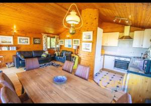 a living room with a table and a kitchen at Five Waterings - Puddock Farm Romney Marsh in Brookland