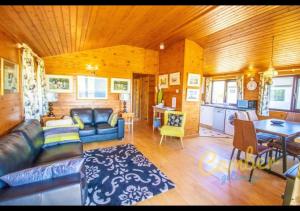 a living room with a couch and a table at Five Waterings - Puddock Farm Romney Marsh in Brookland