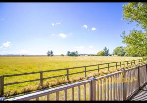 a wooden fence next to a field of grass at Five Waterings - Puddock Farm Romney Marsh in Brookland +5 photos