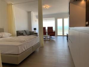a bedroom with a bed and a living room at Super Modern Studio with Sea View T66 in Ostend
