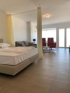 a bedroom with a bed and a living room at Super Modern Studio with Sea View T66 in Ostend