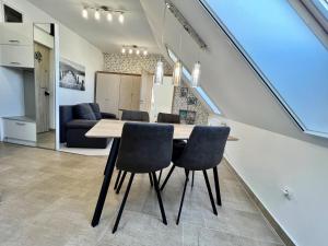 a dining room with a table and chairs at Móló Resort 25 by HelloBalatonlelle in Balatonlelle