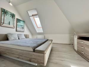 a bedroom with a bed and a skylight at Móló Resort 25 by HelloBalatonlelle in Balatonlelle