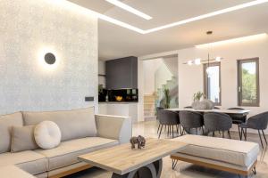 a living room with a couch and a table at Villa Frantzeska - Elegant Villa close to Tsilivi, by ZanteWize in Tsilivi