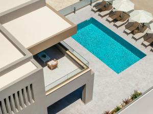 an overhead view of a swimming pool with lounge chairs and a swimming pool at Villa Frantzeska - Elegant Villa close to Tsilivi, by ZanteWize in Tsilivi