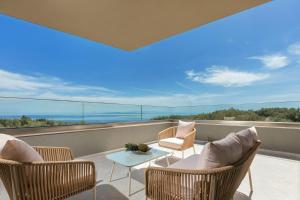 a balcony with chairs and a table with a view at Villa Frantzeska - Elegant Villa close to Tsilivi, by ZanteWize in Tsilivi