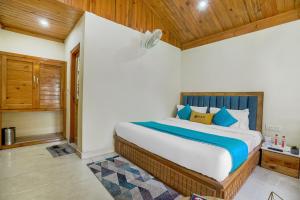 a bedroom with a large bed with wooden ceilings at Pax Hotel Rock Villa Swimming Pool Available Dalhousie in Dalhousie +52 photos