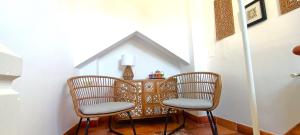 two chairs and a table in a room at Casa Taracea del Chapiz in Granada +13 photos
