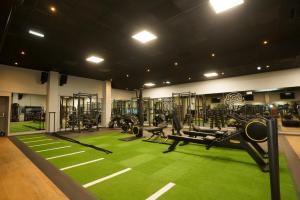 a gym with lots of equipment on a green carpet at Park hall Hotel & Spa Lancashire, a member of Radisson Individuals in Eccleston