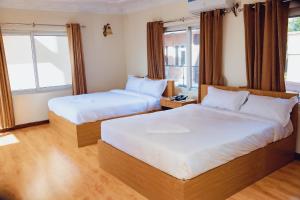 Postel nebo postele na pokoji v ubytování Hotel Sabari