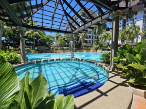 an overhead view of a swimming pool with a glass roof at Good2Stay Apartment 6-8pax l 3R2B l 2 Parking l Coway Water l Unifi I Swimming Pool in Malacca