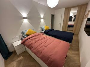 a small bedroom with a large bed in a room at PARIS-MONTROUGE Magnifique appartement 3 pièces de 78m2 avec PARKING - très cosy pour 1 - 6 personnes refait à NEUF -ENTIRE APARTMENT LUXURIOUS AND WARM -Montrouge Paris 14ème - Proche Aéroport Orly Parc Expositions Porte de Versailles FREE WIFI GRATUIT in Montrouge