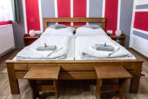 a bed with two pillows on top of it at Air&Day in Vecsés