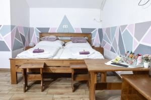a bedroom with a bed and a wooden table at Air&Day in Vecsés