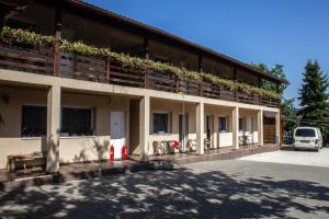 a building with plants on the balconies of it at Air&Day in Vecsés