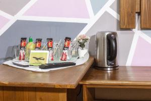 a table with a coffee maker and a keyboard on it at Air&Day in Vecsés