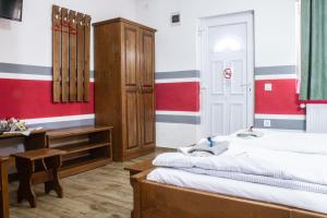 a bedroom with a bed and a sink and a desk at Air&Day in Vecsés