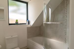 a bathroom with a shower and a bath tub at Beautiful town centre apartment in Huntingdon
