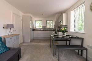 a kitchen and living room with a table and a couch at Beautiful town centre apartment in Huntingdon