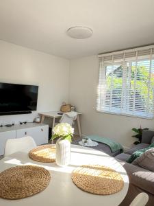 a living room with a couch and a table at Oakwood park apartment in Kaunas