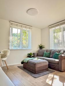 a living room with a couch and some windows at Oakwood park apartment in Kaunas