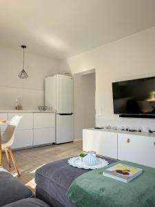 a living room with a refrigerator and a table at Oakwood park apartment in Kaunas