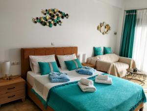 a bedroom with a bed with towels on it at ILIOPOULOS Apartments in Mourteri