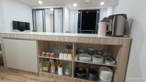a room with a counter with plates and utensils at A Tower Dream Home in Sibu
