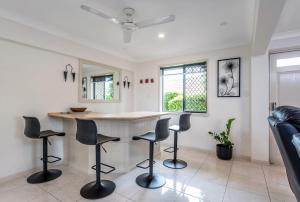 a kitchen with a table and chairs in a room at Seaside Serenity at Plumeria Place in Brisbane