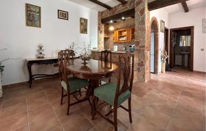 a kitchen and dining room with a wooden table and chairs at 3 Bedroom Cozy Home In El Chorro, Alora in El Chorro