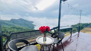 a table with a vase of flowers on a balcony at ออโต้แคมป์ in Ban Huai Khu +13 photos
