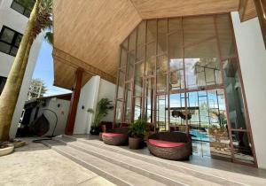 a building with trees and plants in front of it at Poolside 1 Bedroom Apartment by Renttini in Surin Beach