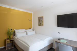 Postel nebo postele na pokoji v ubytování Hotel Kredell