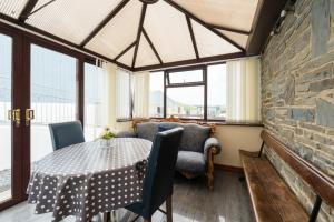 a dining room with a table and a couch at The Barn in Aberystwyth