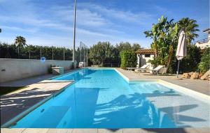 a large blue swimming pool in a backyard at Gorgeous Home In Noto in Noto +40 photos